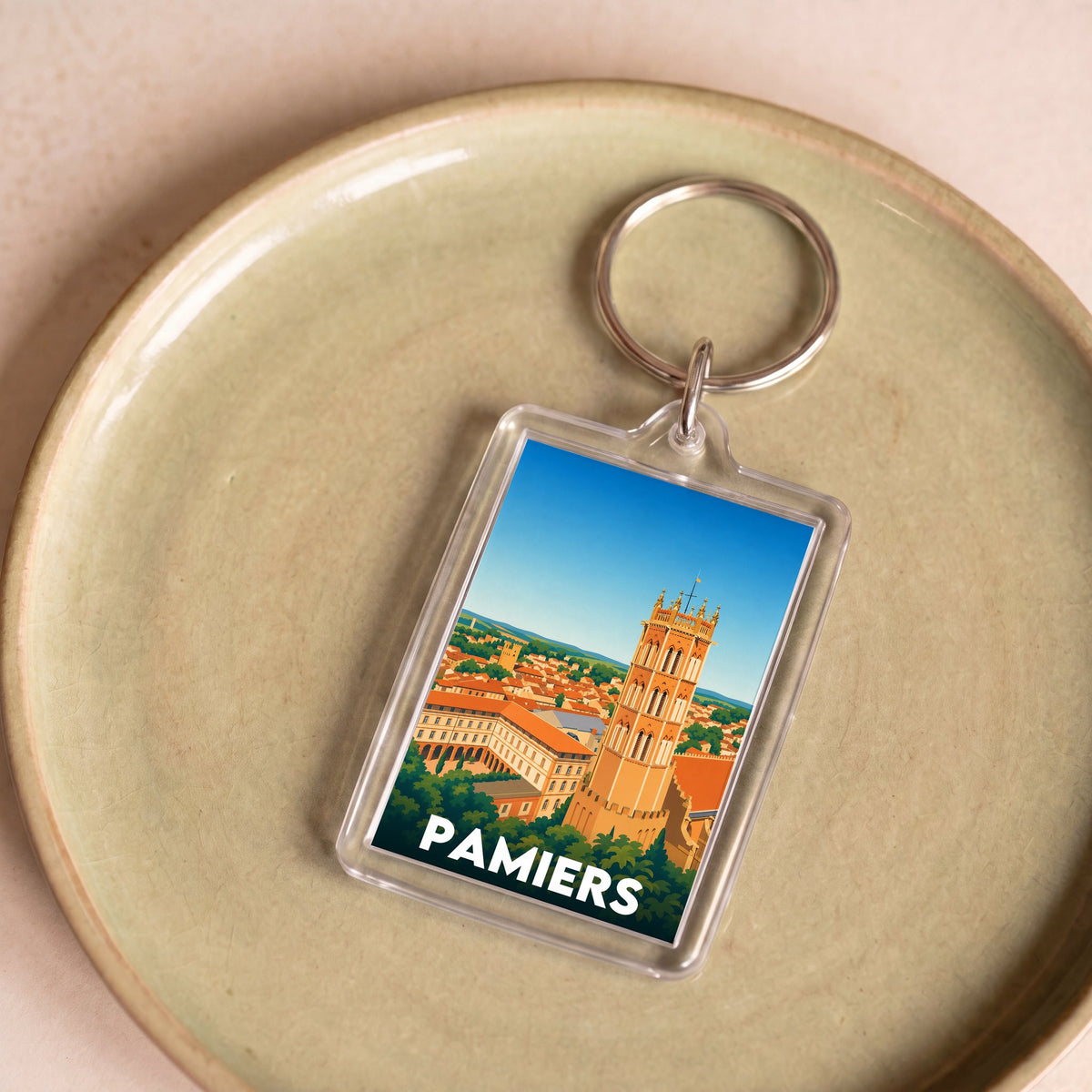 Porte-clés souvenir de la ville de Pamiers avec une illustration stylisée.