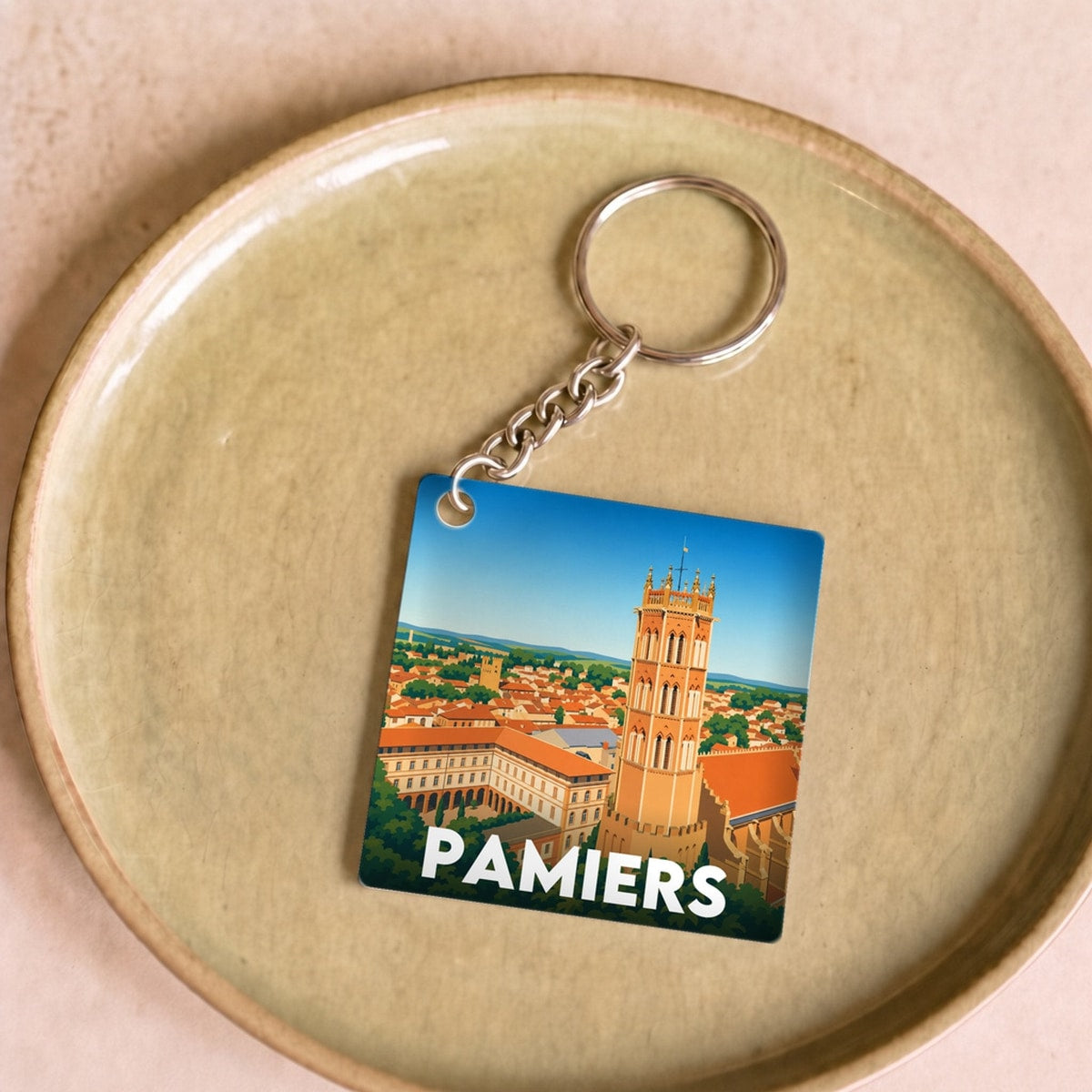 Porte-clés souvenir de la ville de Pamiers avec une illustration stylisée.