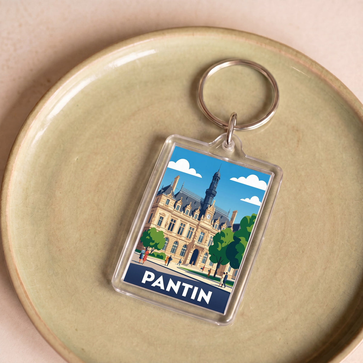 Porte-clés souvenir de la ville de Pantin avec une illustration stylisée de son hôtel de ville.