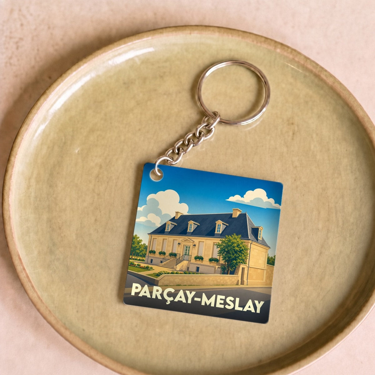 Porte-clés souvenir de la ville de Parçay-Meslay avec une illustration stylisée.