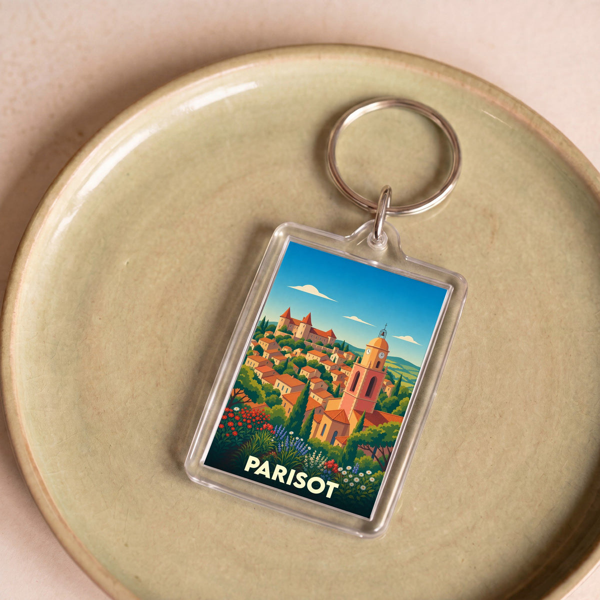 Porte-clés souvenir de la ville de Parisot avec une illustration stylisée et colorée.