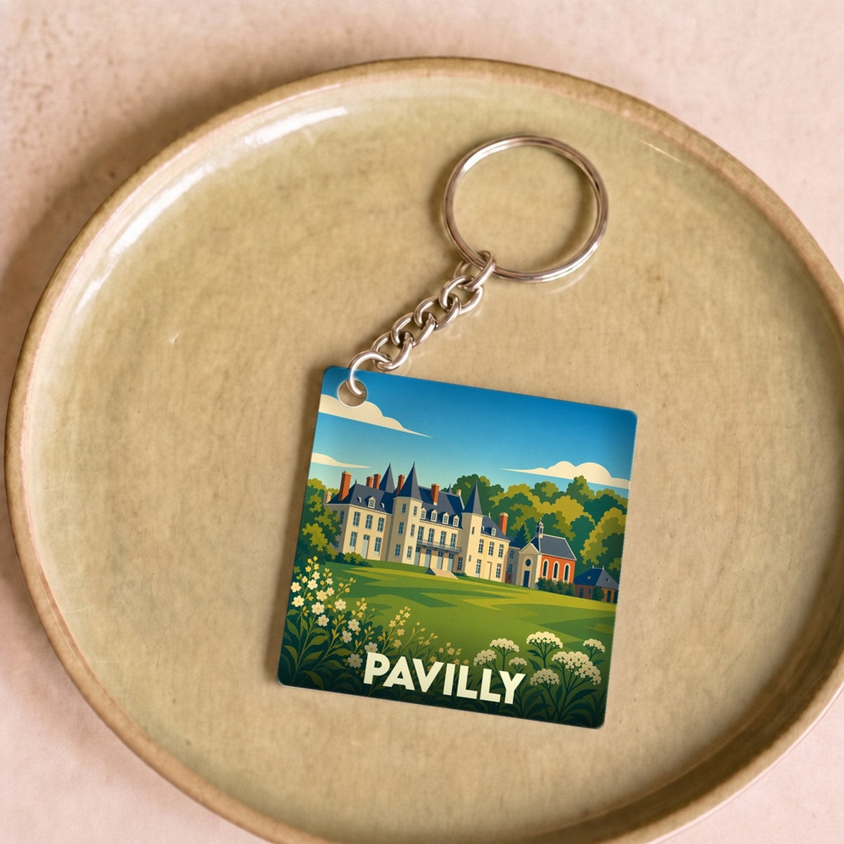 Porte-clés souvenir de la ville de Pavilly avec une illustration stylisée de son château.