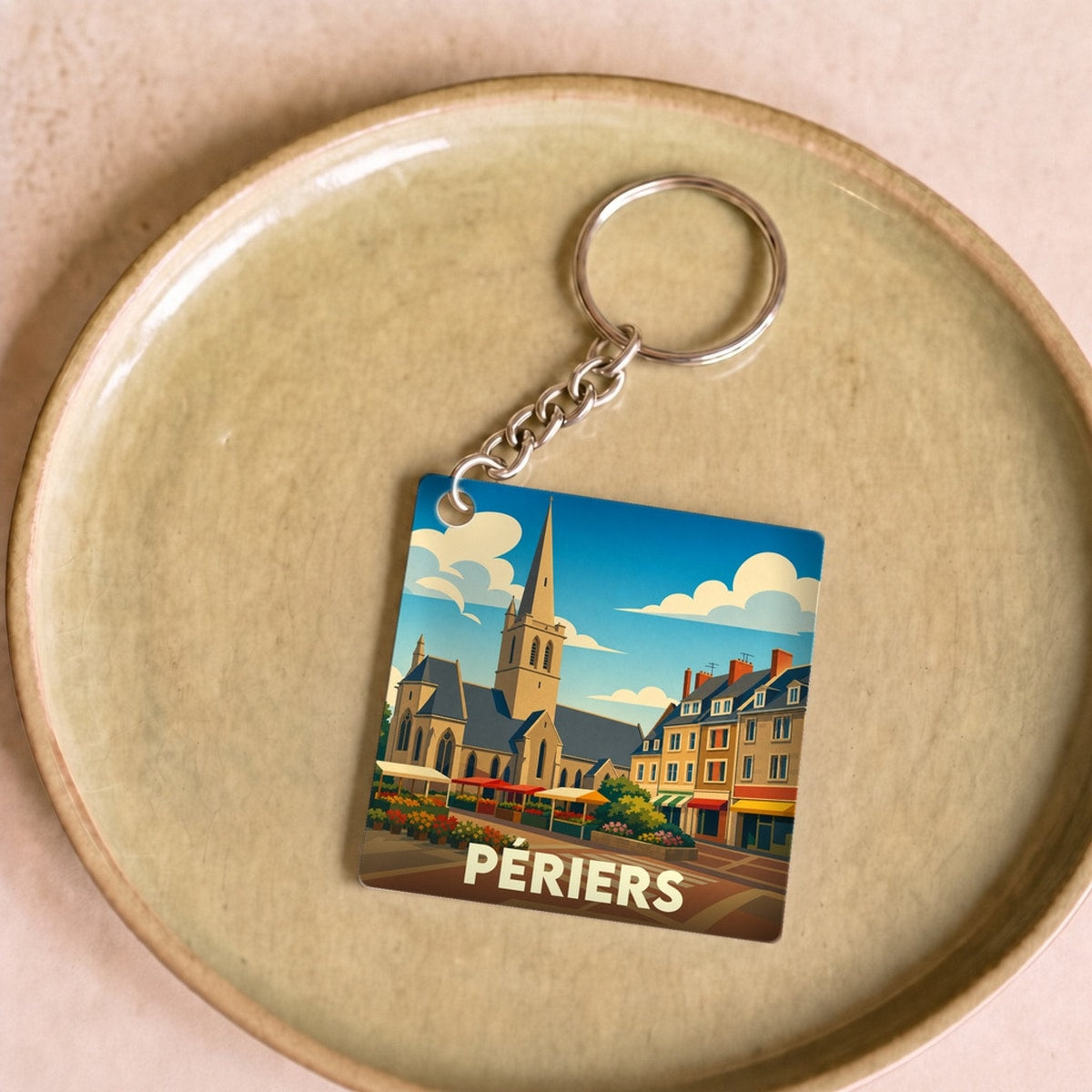 Porte-clés souvenir de la ville de Périers avec une illustration stylisée.