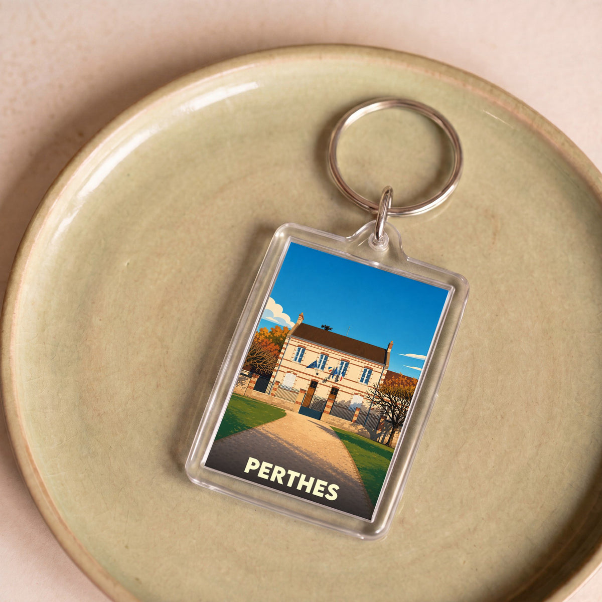 Porte-clés souvenir de la ville de Perthes avec une illustration stylisée.