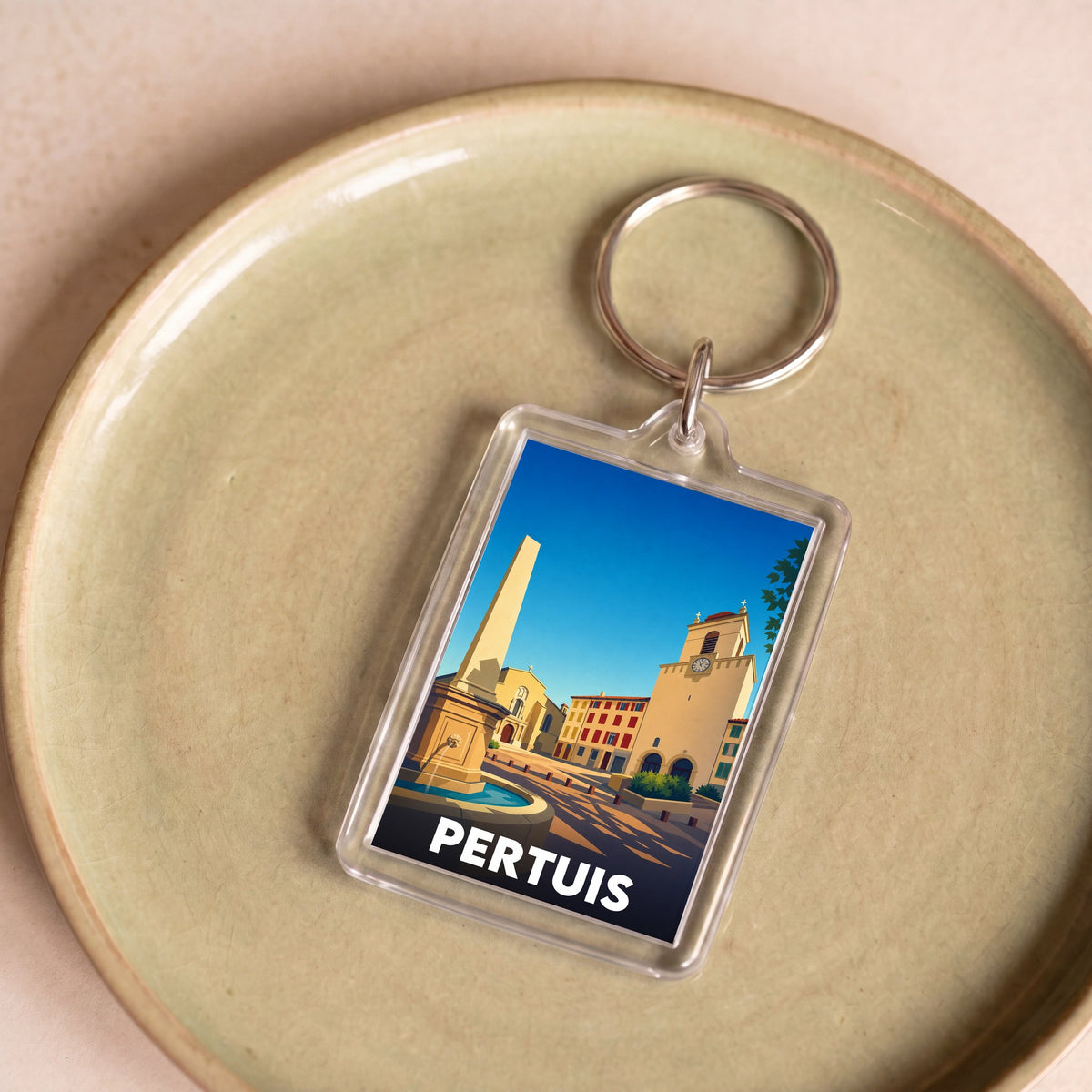 Porte-clés souvenir de la ville de Pertuis avec une illustration stylisée.