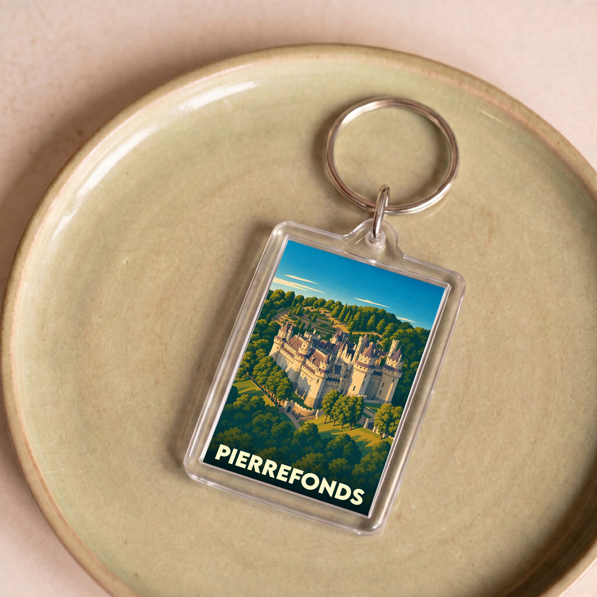 Porte-clés souvenir de la ville de Pierrefonds avec une illustration stylisée de son château.