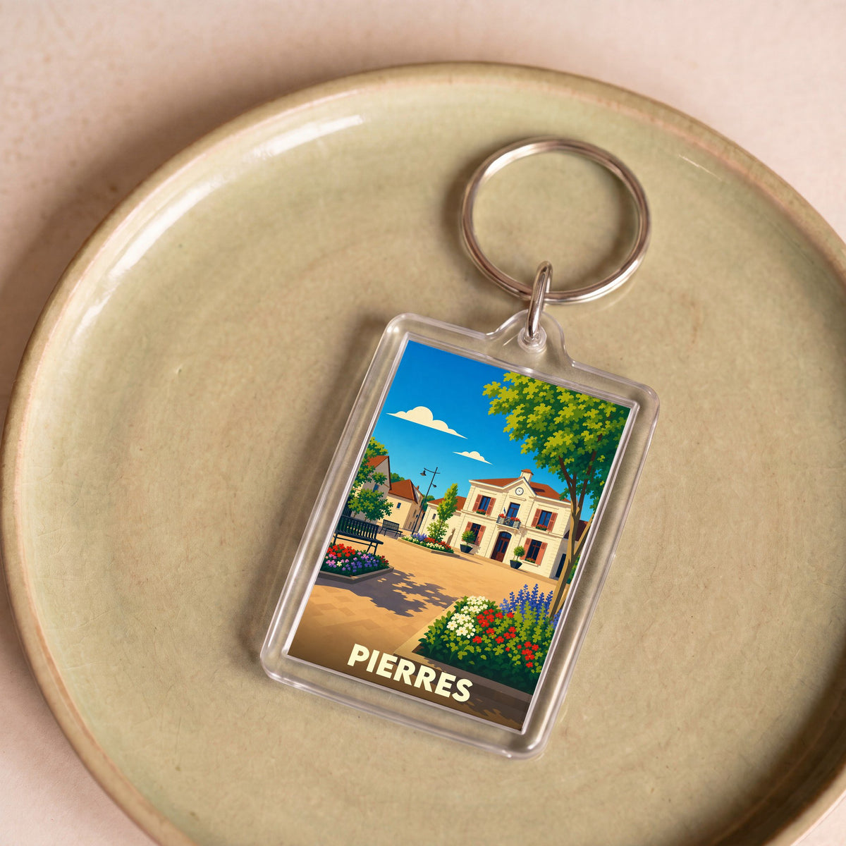 Porte-clés souvenir de la ville de Pierres avec une illustration stylisée.
