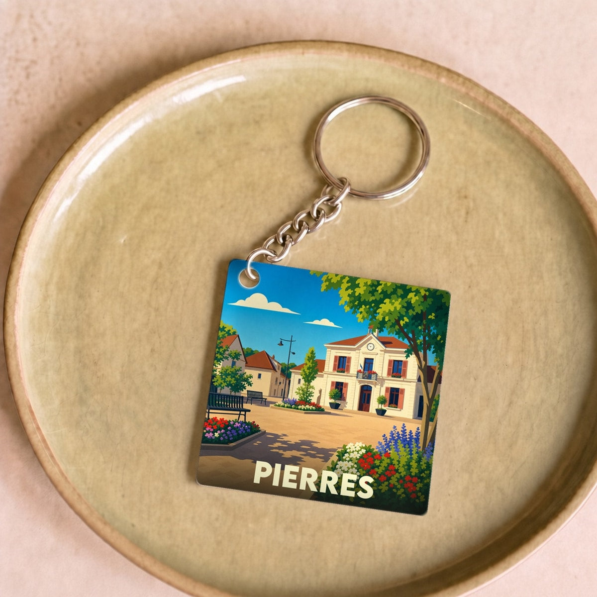 Porte-clés souvenir de la ville de Pierres avec une illustration stylisée.