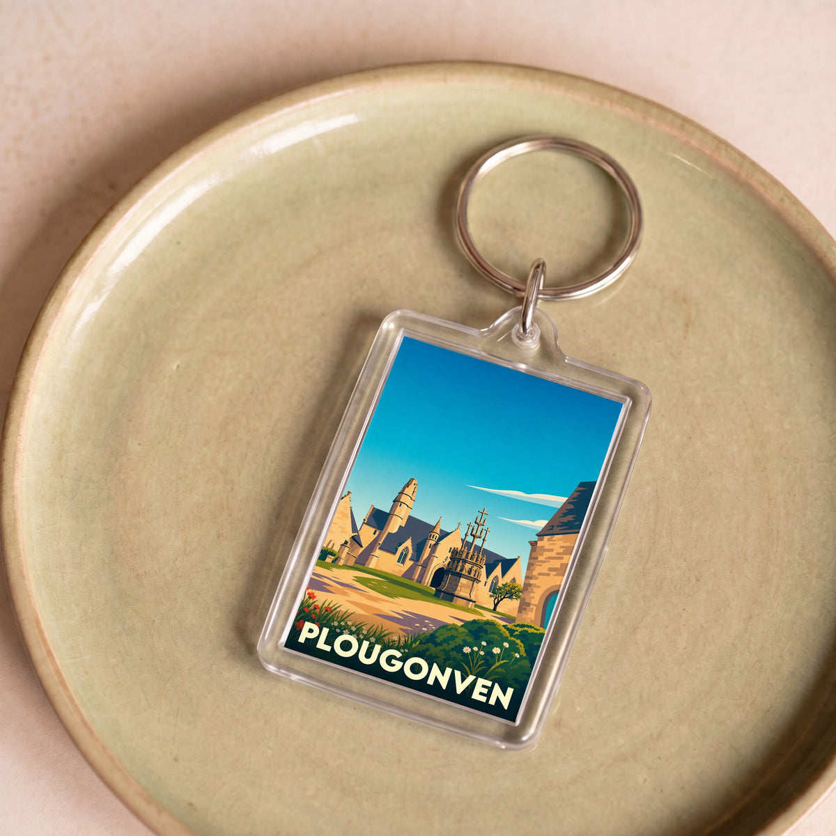 Porte-clés souvenir de la ville de Plougonven avec une illustration stylisée.