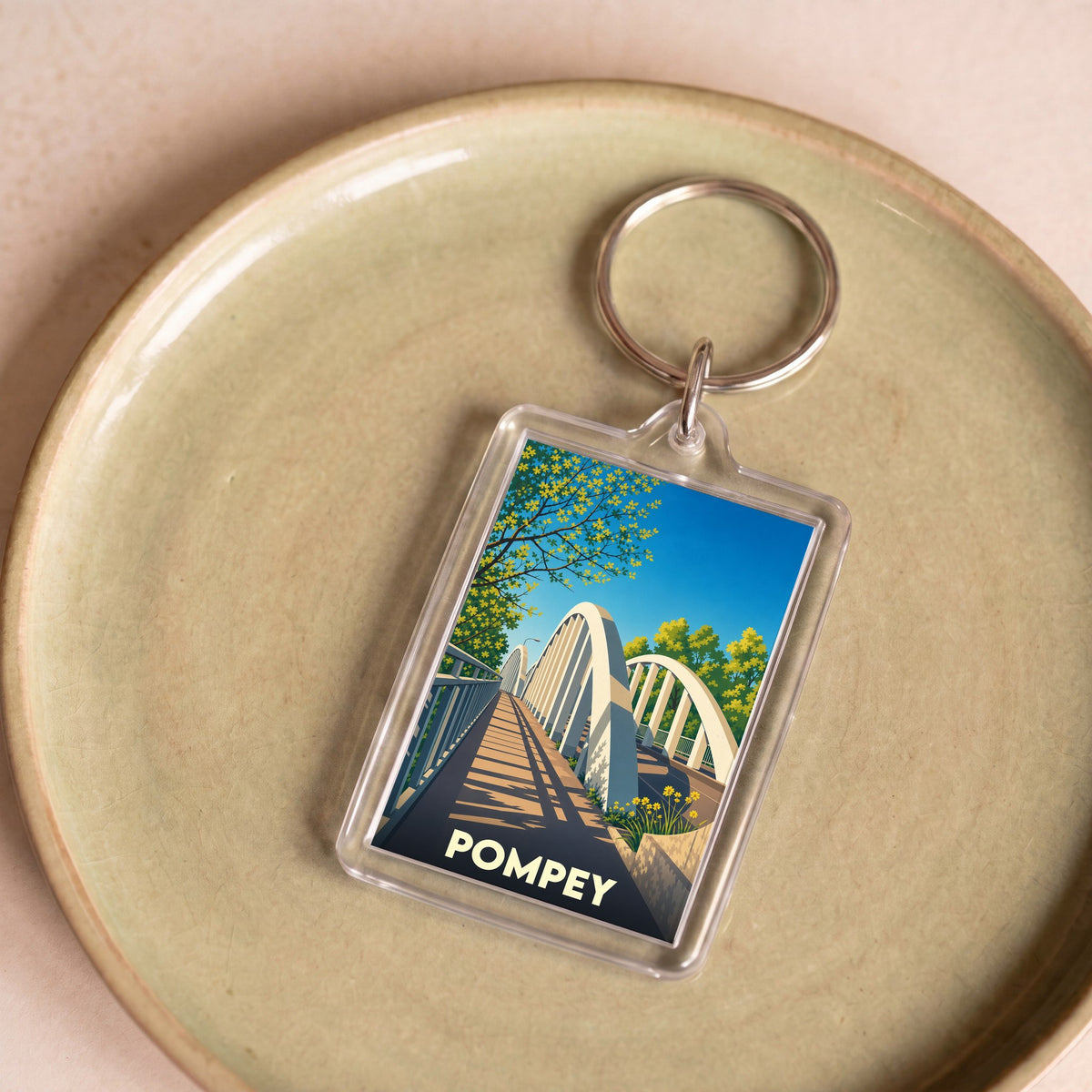 Porte-clés souvenir de la ville de Pompey avec une illustration stylisée de son pont.