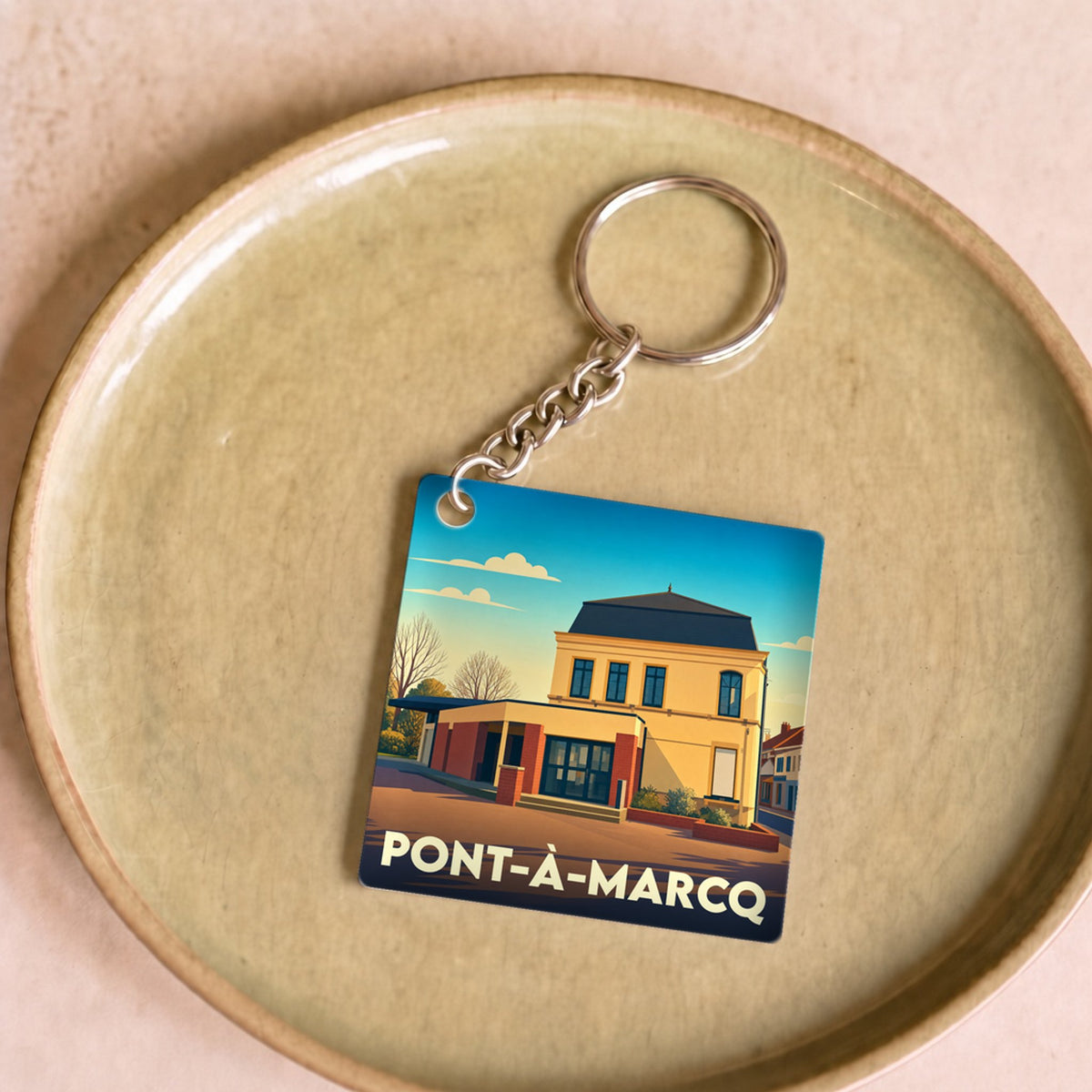 Porte-clés souvenir de la ville de Pont-à-Marcq avec une illustration stylisée de sa mairie.