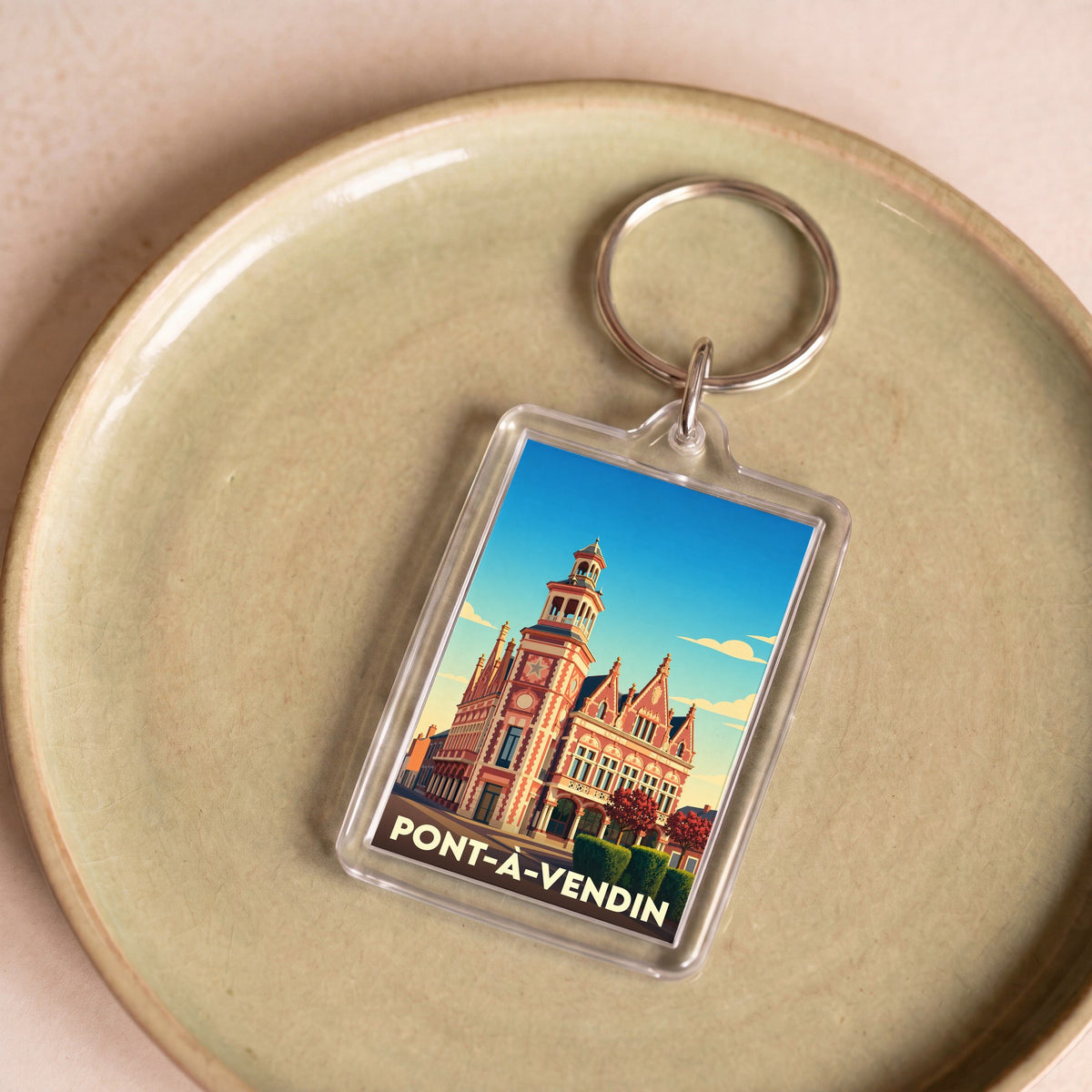 Porte-clés souvenir de la ville de Pont-à-Vendin avec une illustration stylisée de son hôtel de ville.