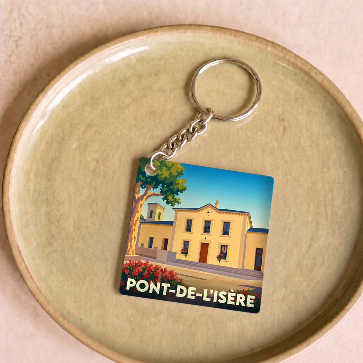 Porte-clés souvenir de la ville de Pont-de-l'Isère avec une illustration stylisée de sa mairie.