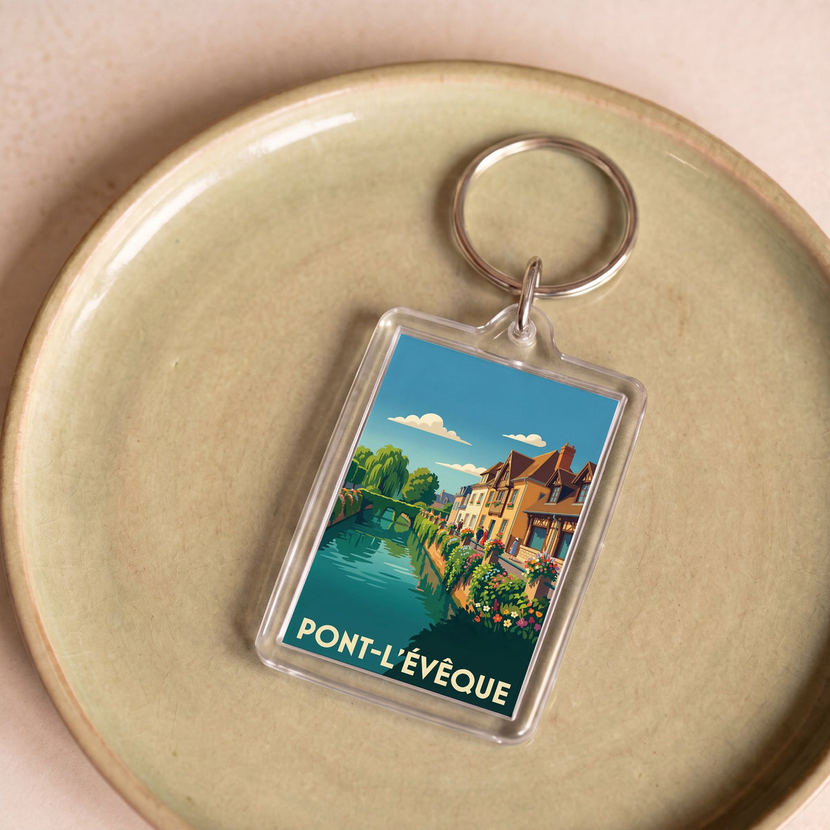 Porte-clés souvenir de la ville de Pont-l'Évêque avec une illustration stylisée.