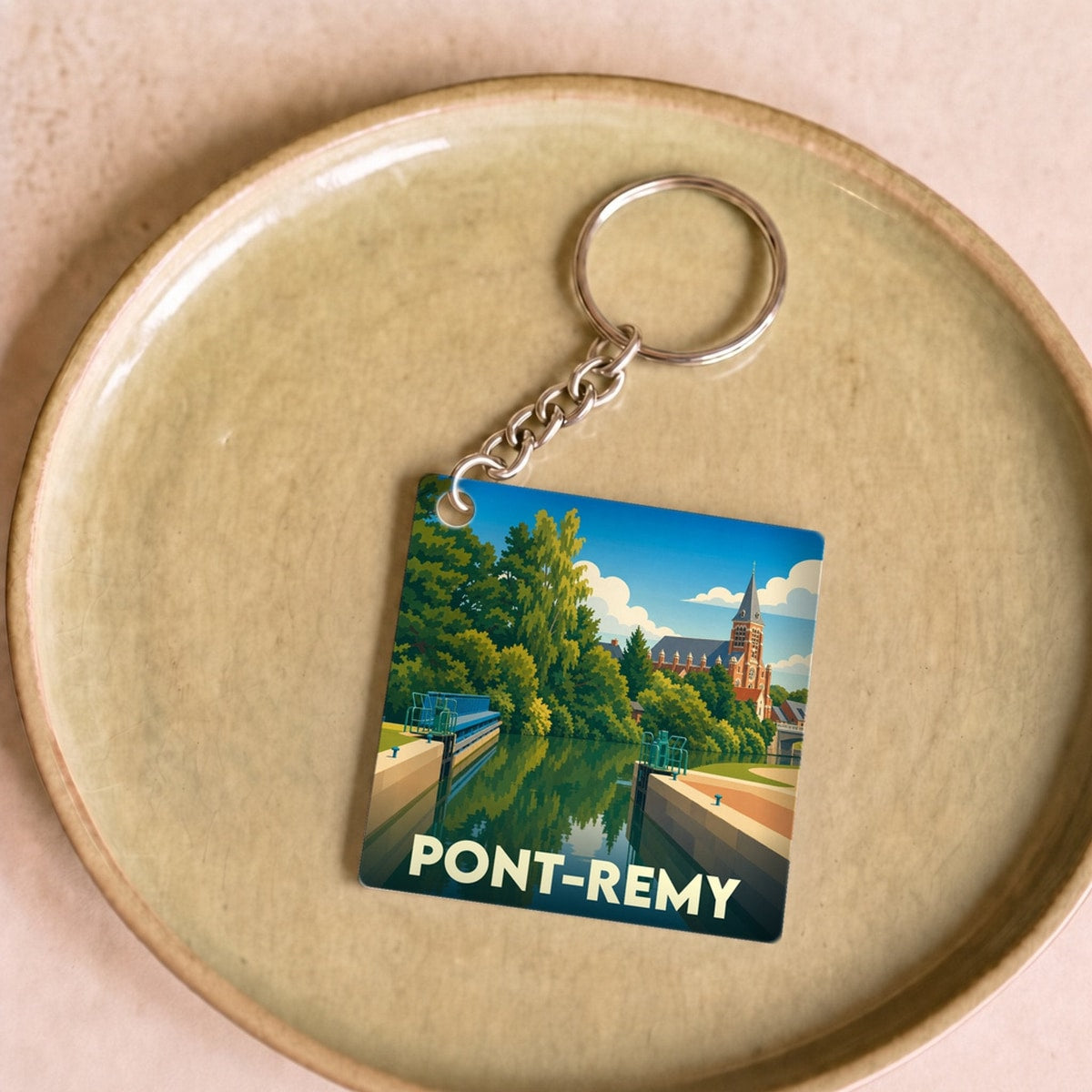 Porte-clés souvenir de la ville de Pont-Remy avec une illustration stylisée.