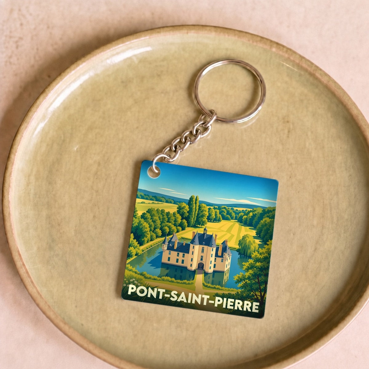 Porte-clés souvenir de la ville de Pont-Saint-Pierre avec une illustration stylisée d'un château entouré de douves.