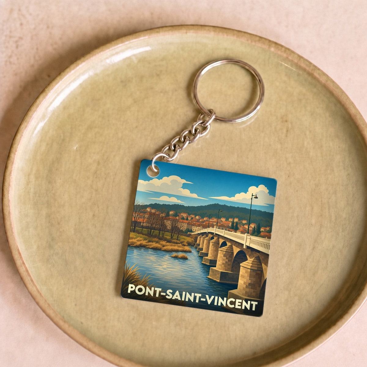 Porte-clés souvenir de la ville de Pont-Saint-Vincent avec une illustration stylisée d'un pont en pierre sur une rivière.