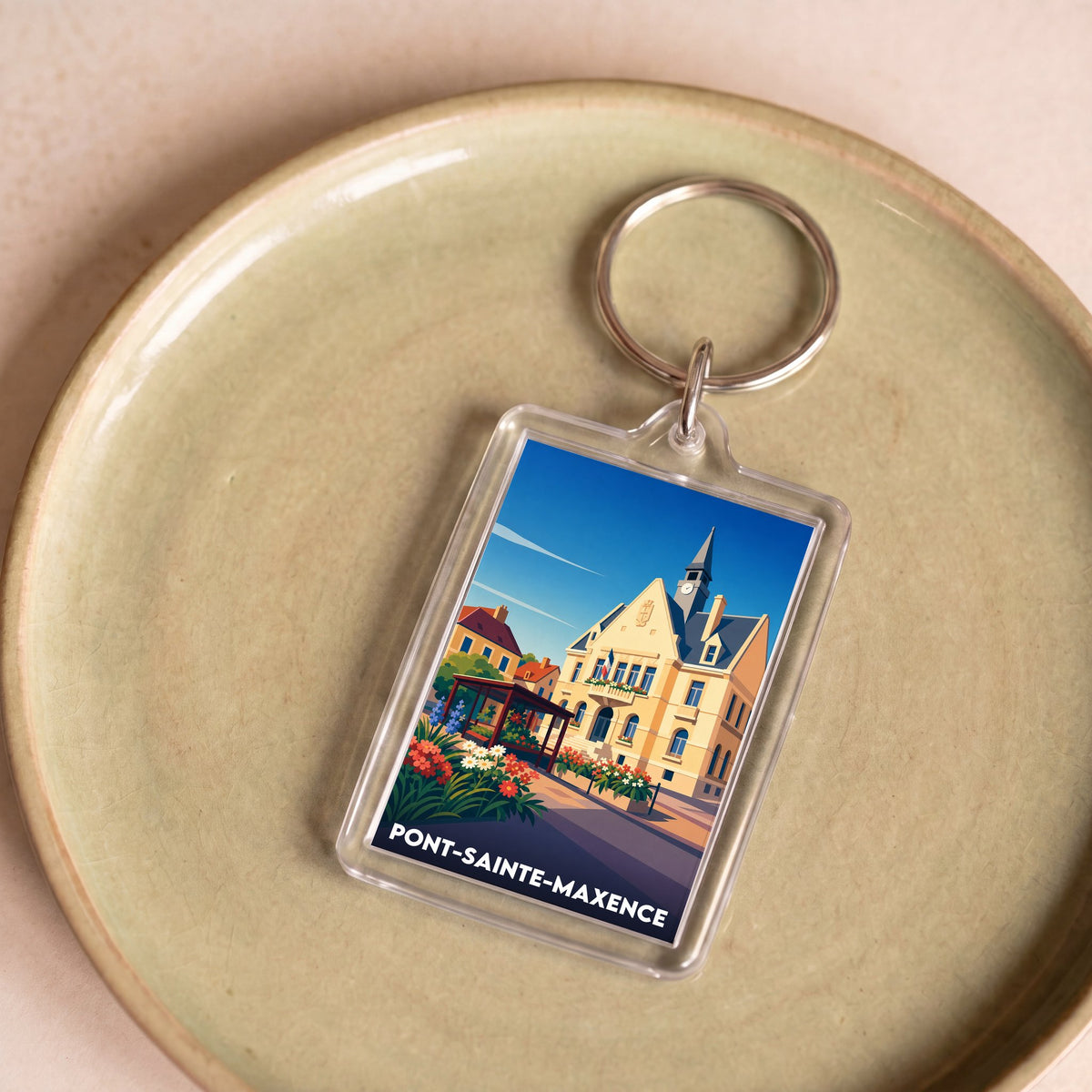 Porte-clés souvenir de la ville de Pont-Sainte-Maxence avec une illustration stylisée.