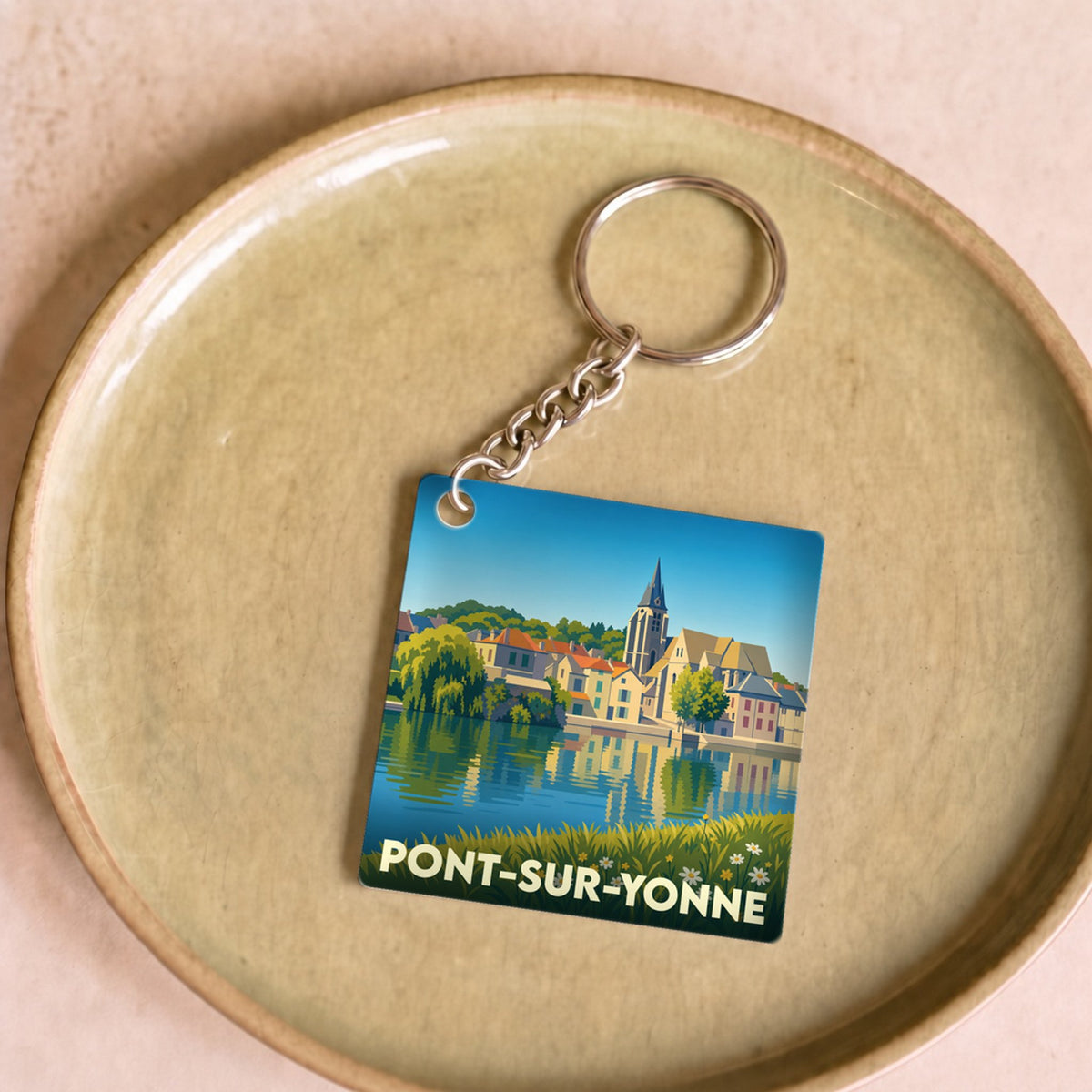 Porte-clés souvenir de la ville de Pont-sur-Yonne avec une illustration stylisée des bords de l'Yonne.