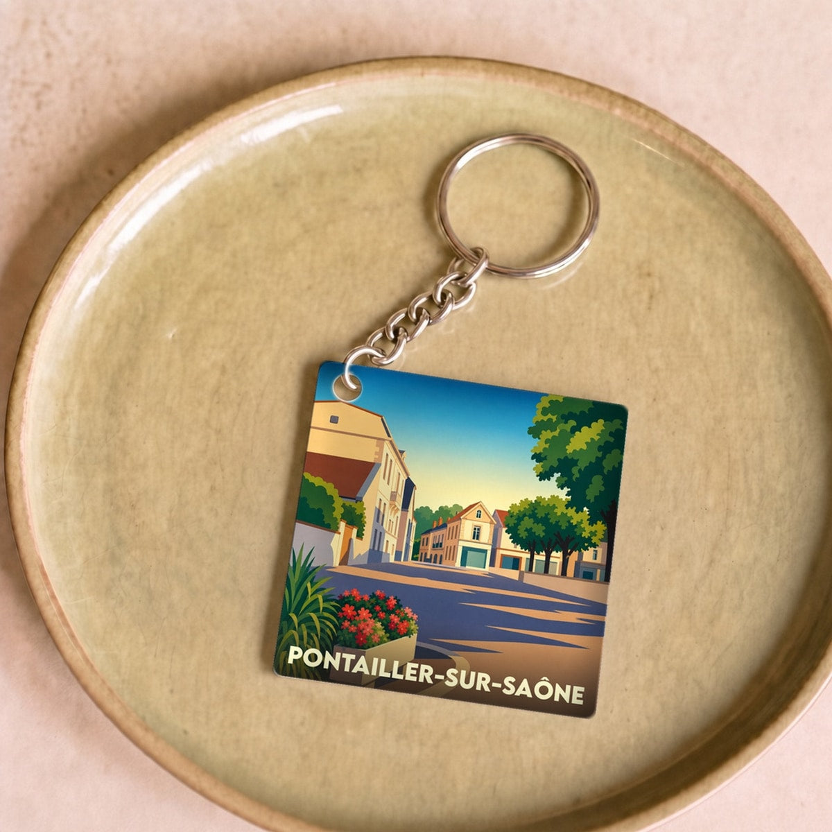 Porte-clés souvenir de la ville de Pontailler-sur-Saône avec une illustration stylisée.