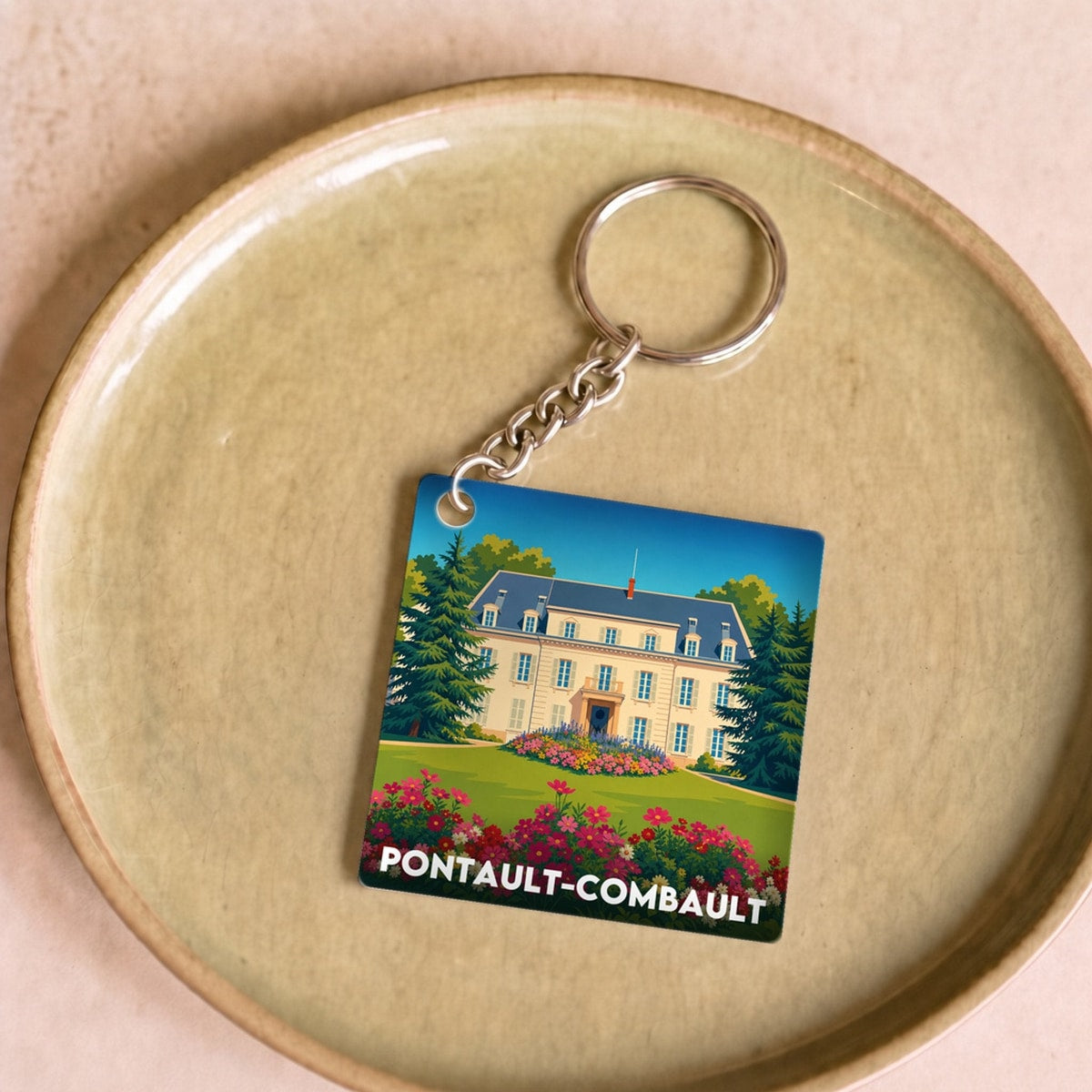 Porte-clés souvenir de la ville de Pontault-Combault avec une illustration stylisée.