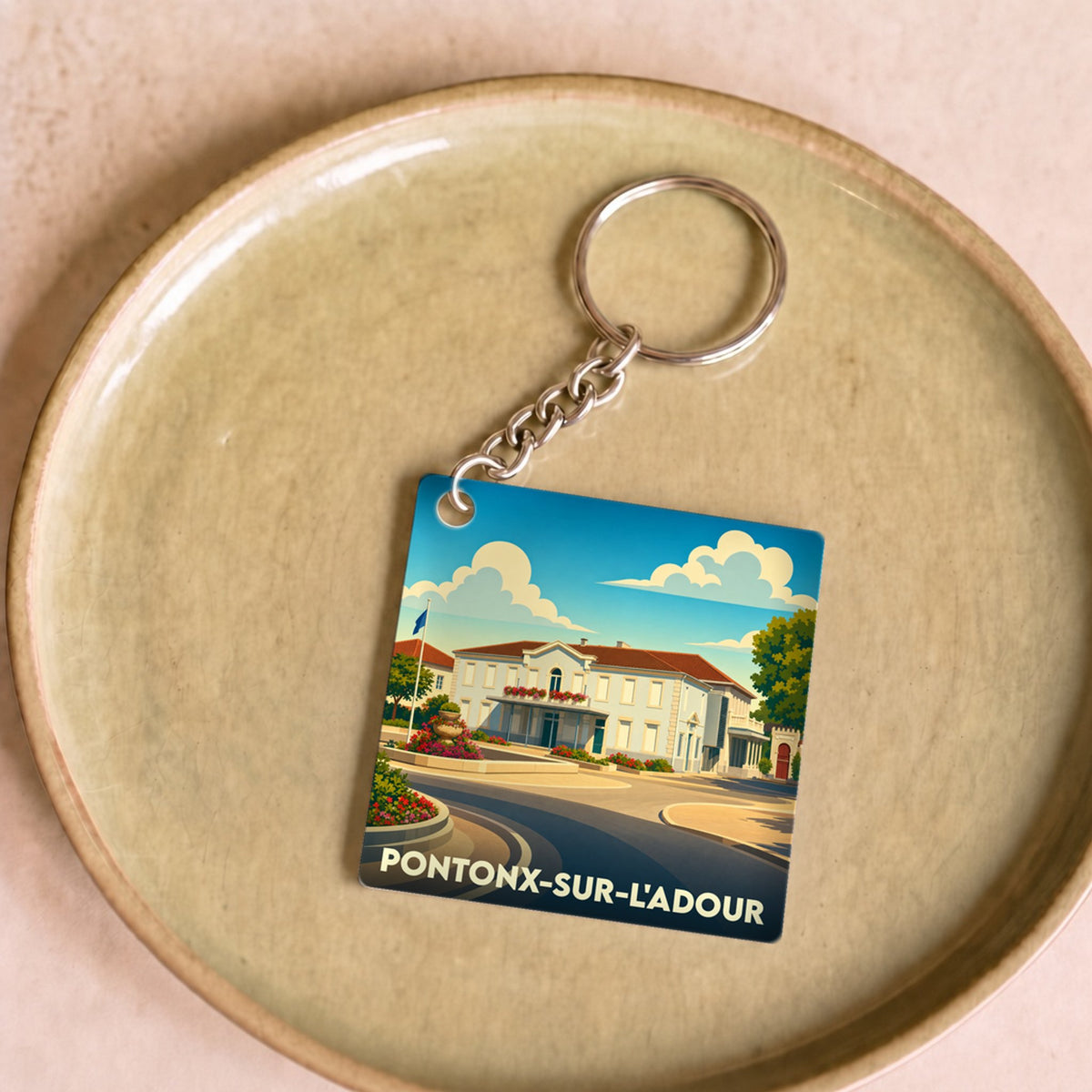 Porte-clés souvenir de la ville de Pontonx-sur-l'Adour avec une illustration stylisée.