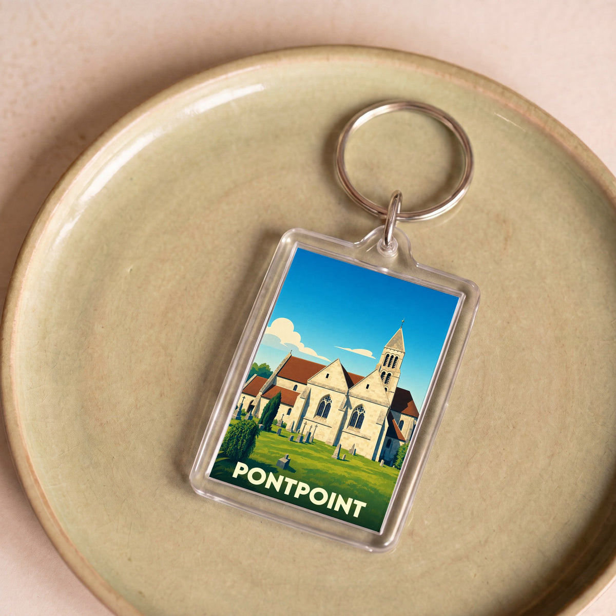 Porte-clés souvenir de la ville de Pontpoint avec une illustration stylisée de son église.