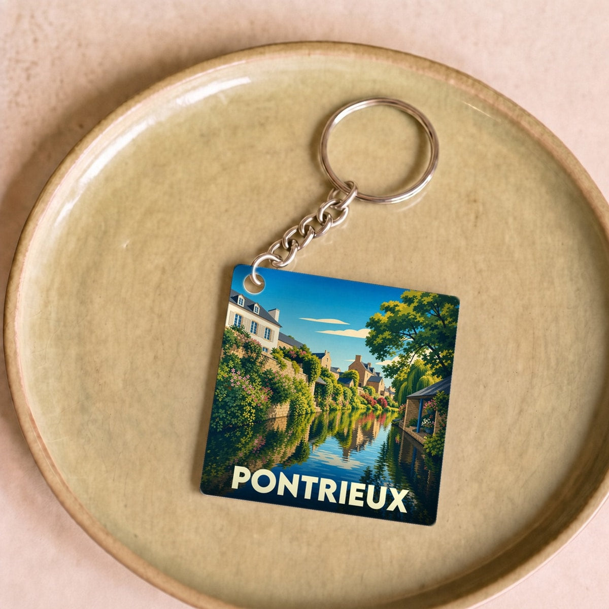 Porte-clés souvenir de la ville de Pontrieux avec une illustration stylisée de ses canaux.