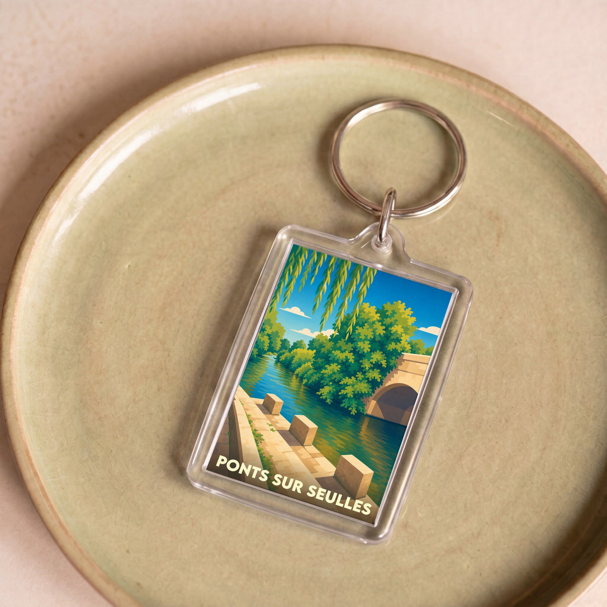 Porte-clés souvenir de la ville de Ponts sur Seulles avec une illustration stylisée.