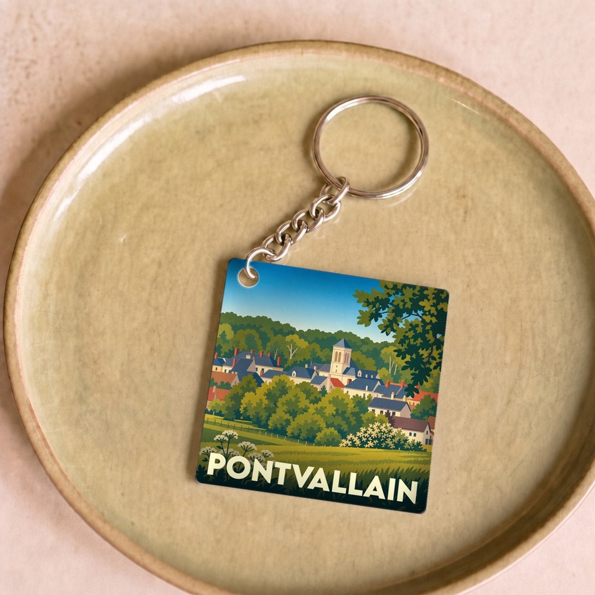 Porte-clés souvenir de la ville de Pontvallain avec une illustration stylisée.