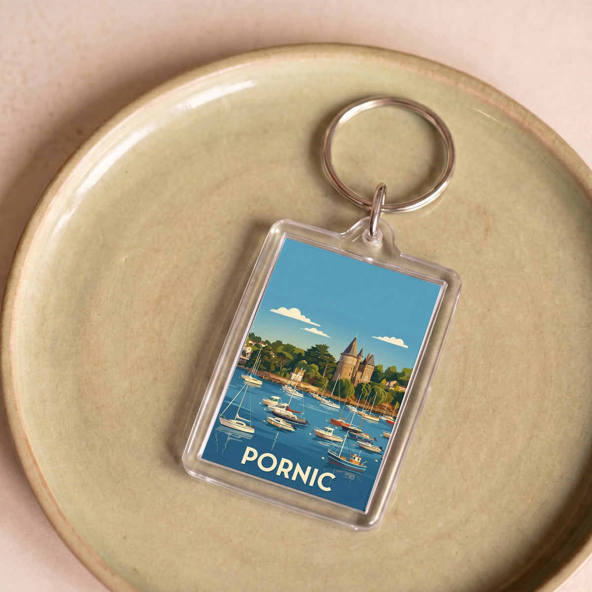 Porte-clés souvenir de la ville de Pornic avec une illustration stylisée.