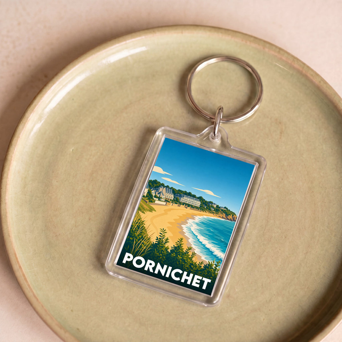 Porte-clés souvenir de la ville de Pornichet avec une illustration stylisée de sa plage.