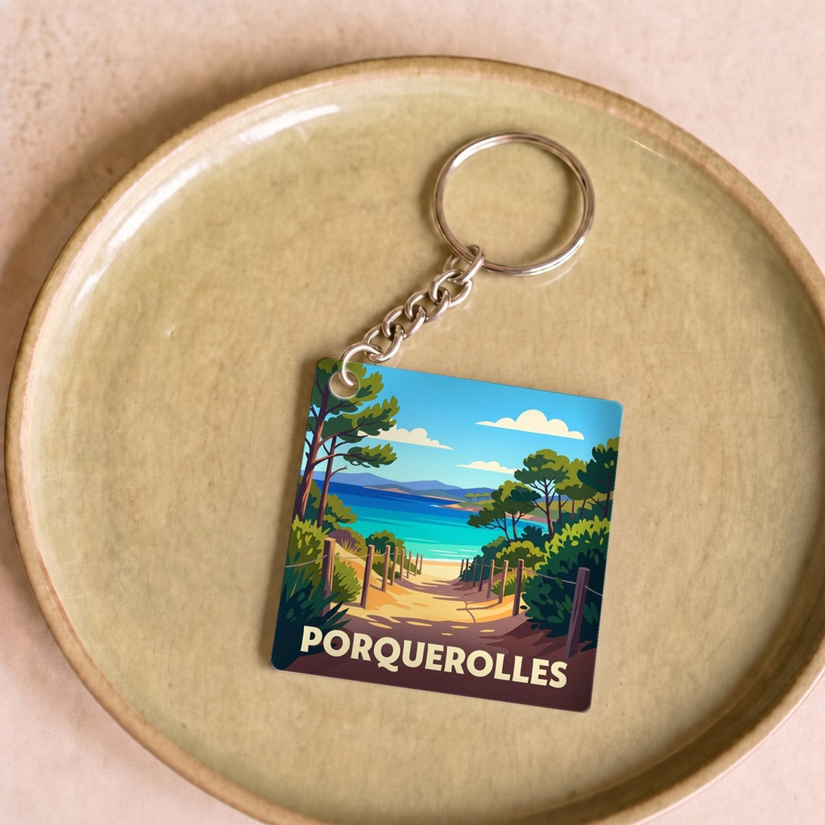 Porte-clés souvenir de la ville de Porquerolles avec une illustration stylisée.