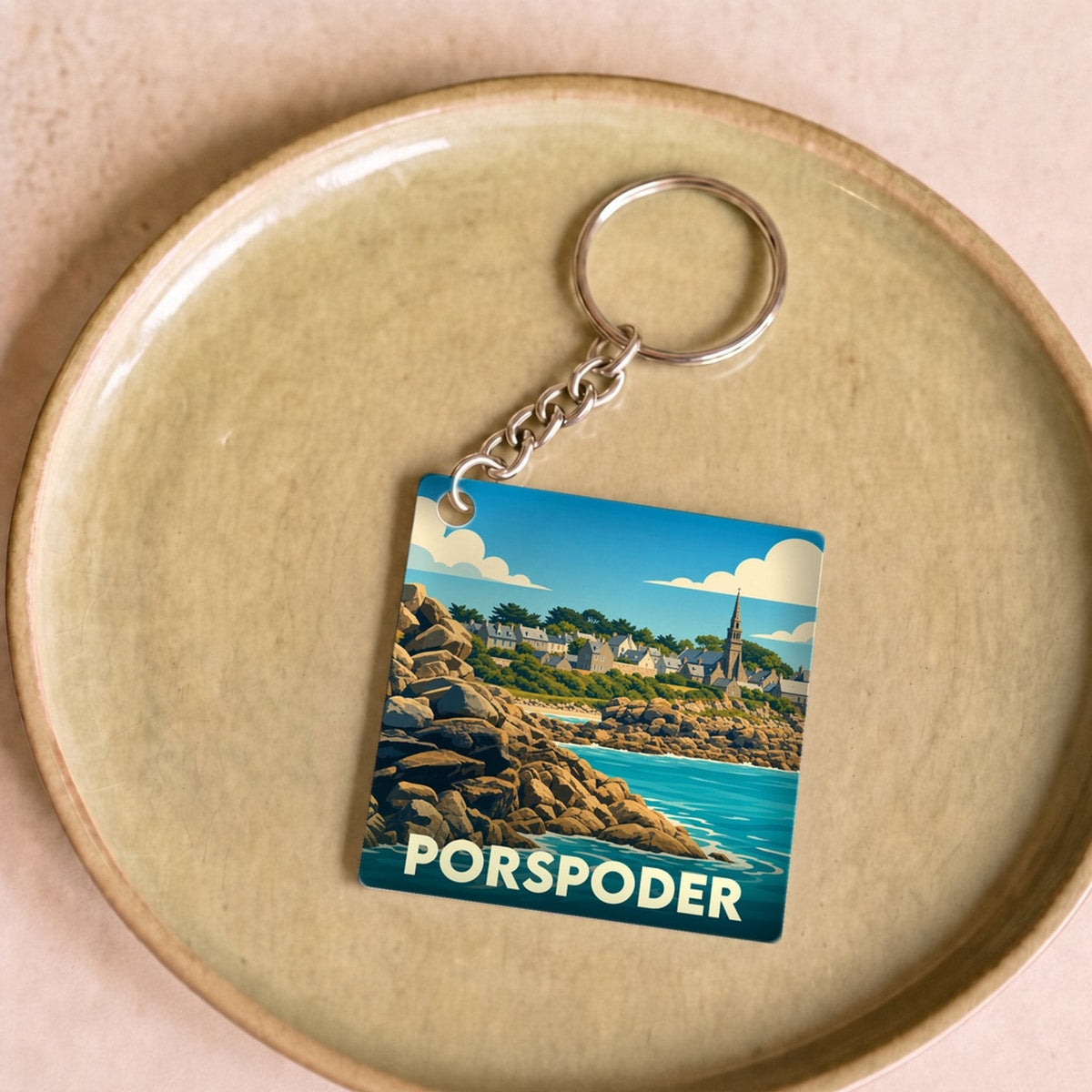 Porte-clés souvenir de la ville de Porspoder avec une illustration stylisée de son paysage côtier.