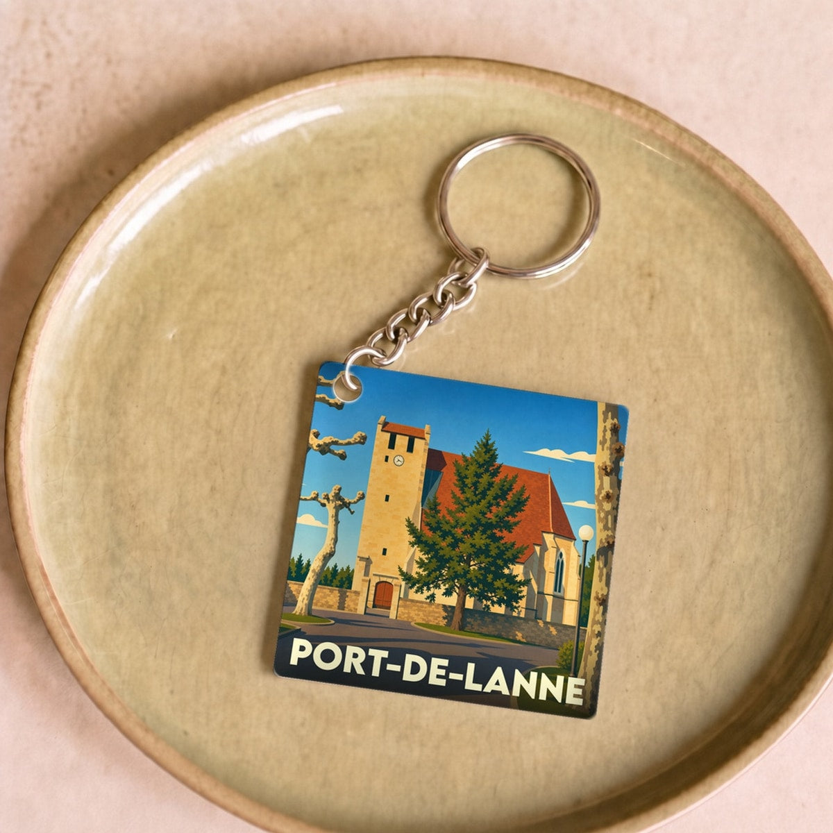 Porte-clés souvenir de la ville de Port-de-Lanne avec une illustration stylisée de son église.