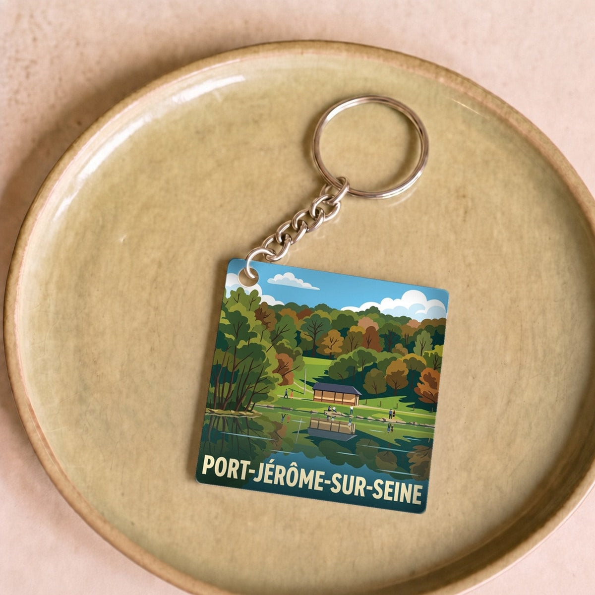 Porte-clés souvenir de la ville de Port-Jérôme-sur-Seine avec une illustration paysagère stylisée.