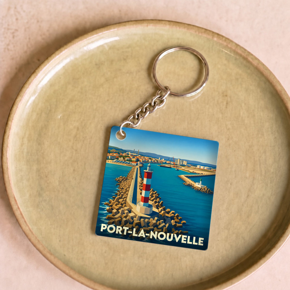 Porte-clés souvenir de la ville de Port-la-Nouvelle avec une illustration stylisée d'un phare.
