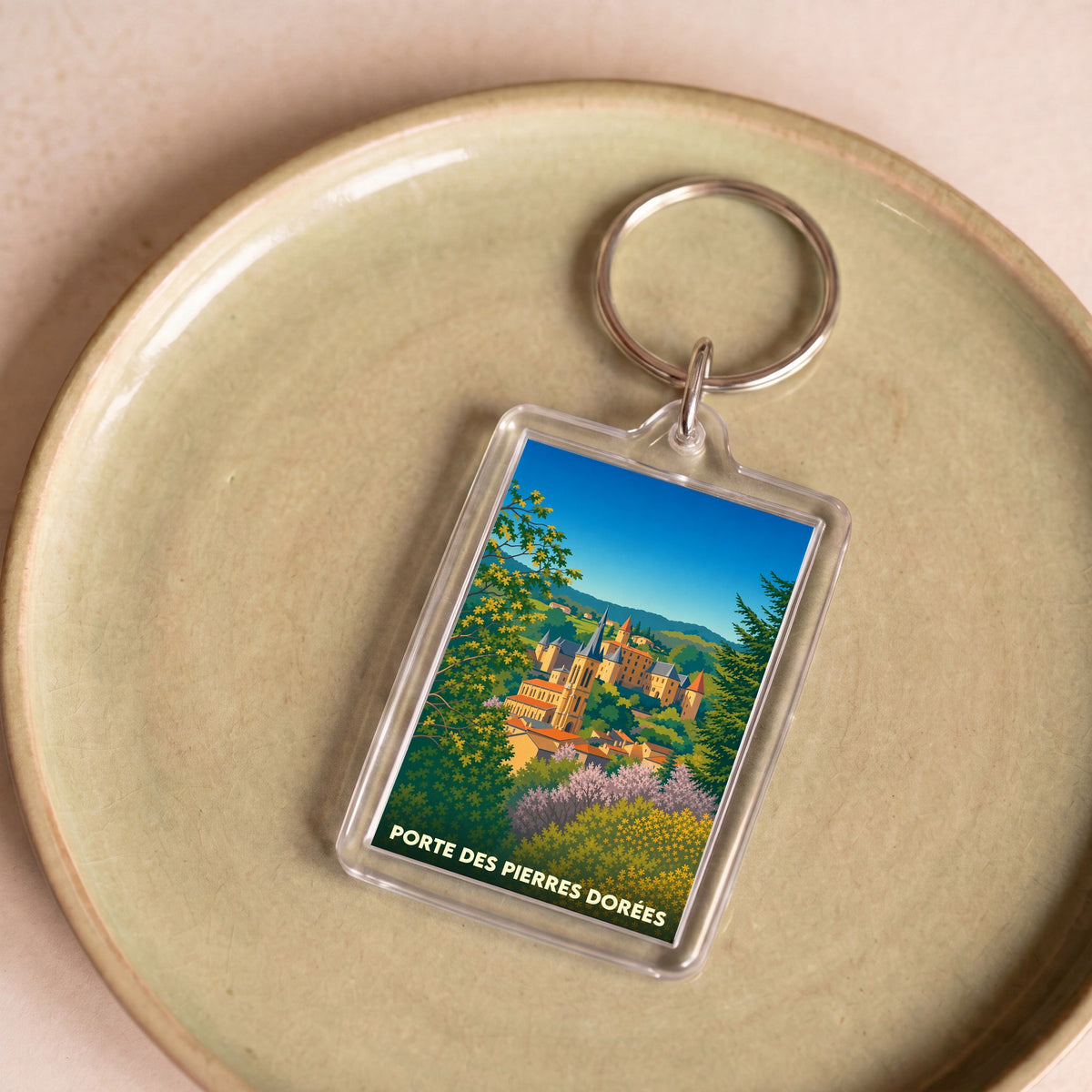 Porte-clés souvenir de la ville de Porte des Pierres Dorées avec une illustration stylisée.