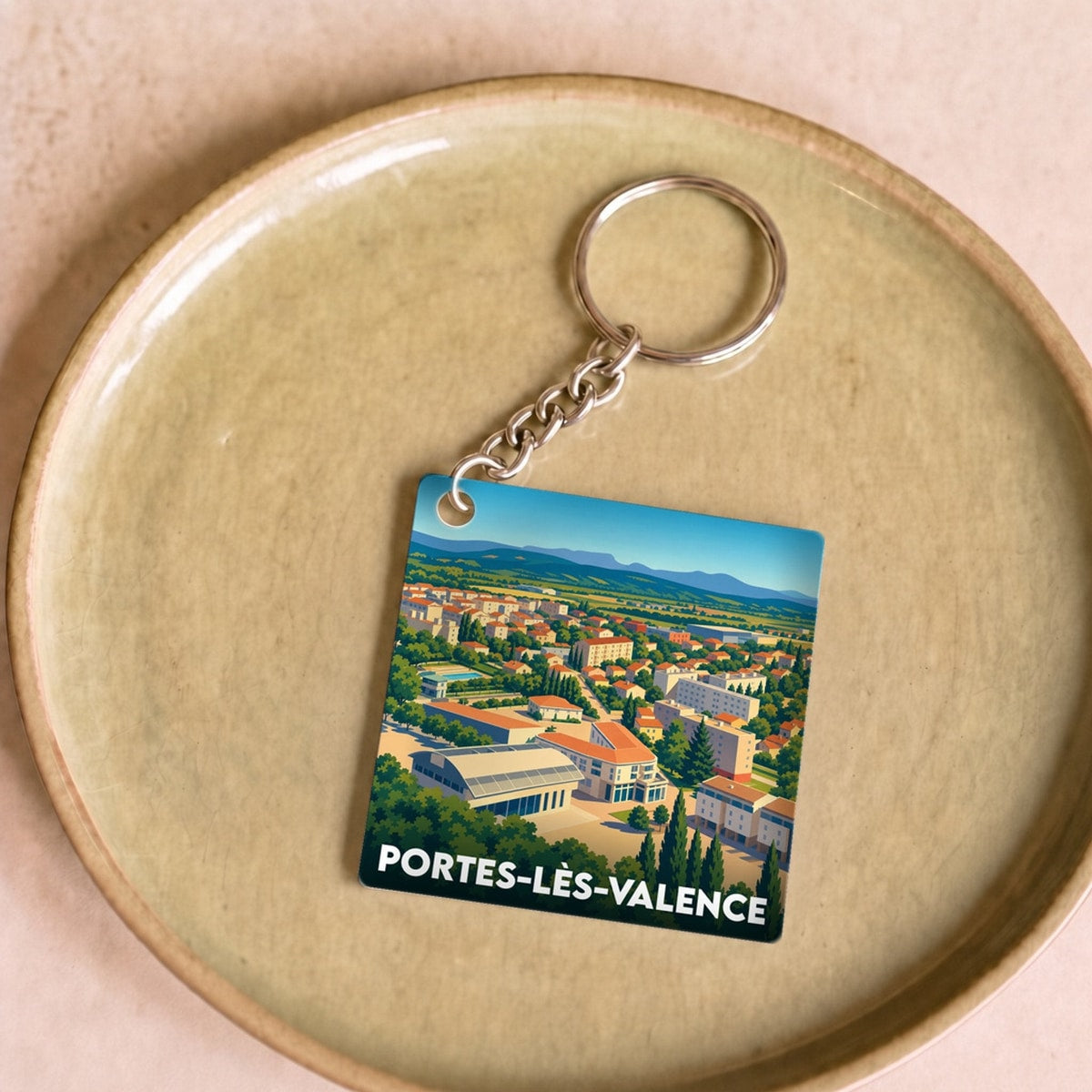 Porte-clés souvenir de la ville de Portes-lès-Valence avec une illustration panoramique stylisée.