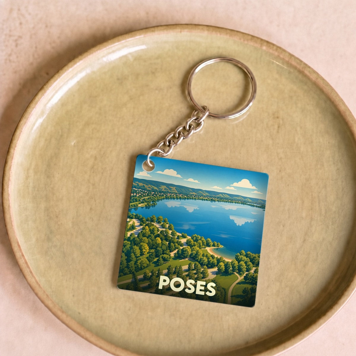Porte-clés souvenir de la ville de Poses avec une illustration stylisée.