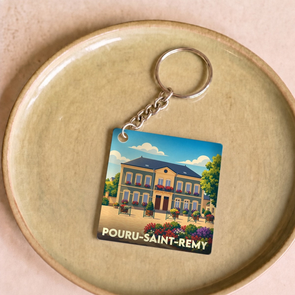 Porte-clés souvenir de la ville de Pouru-Saint-Remy avec une illustration stylisée.