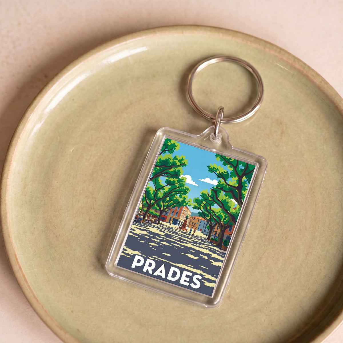 Porte-clés souvenir de la ville de Prades avec une illustration stylisée.