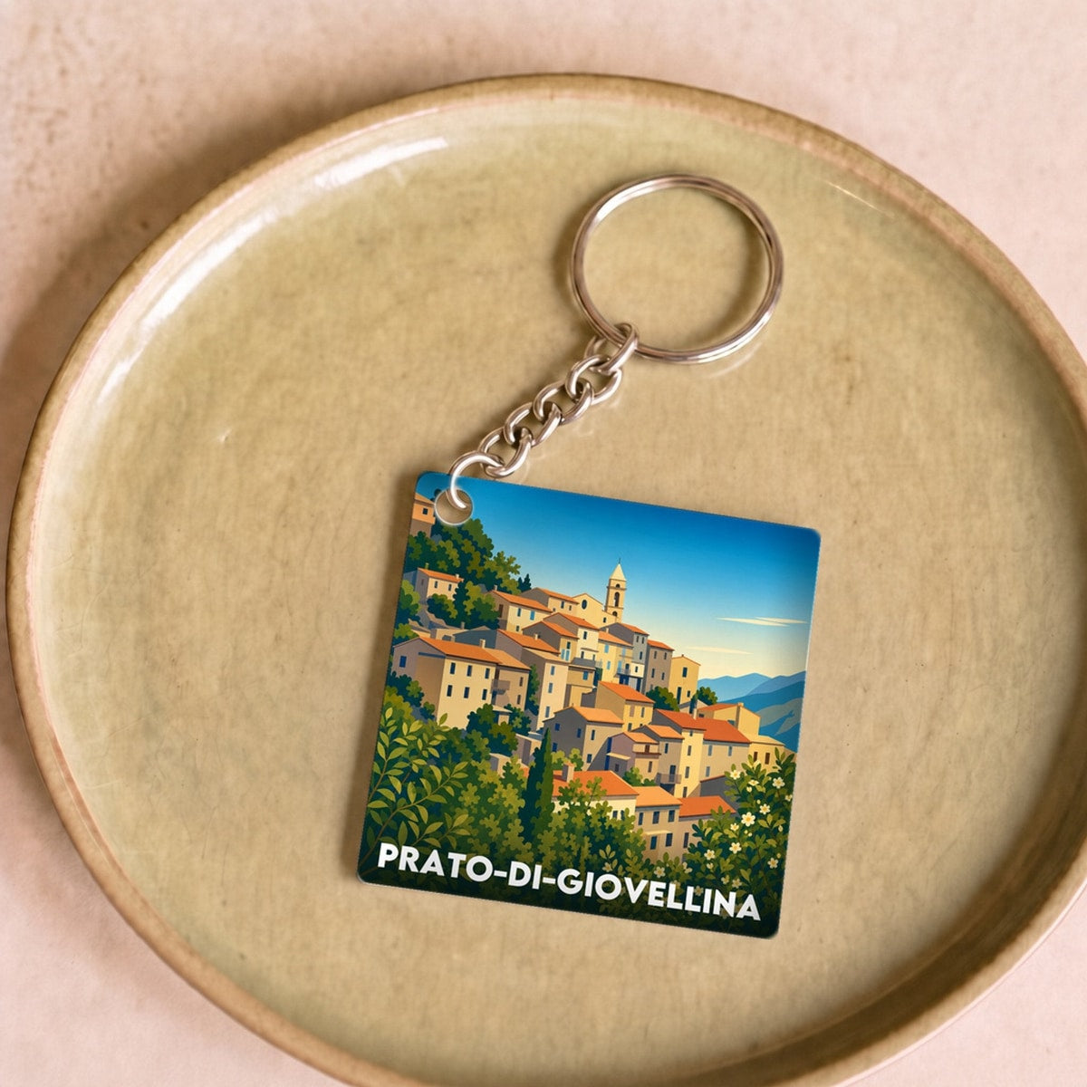 Porte-clés souvenir de la ville de Prato-di-Giovellina avec une illustration stylisée du village.