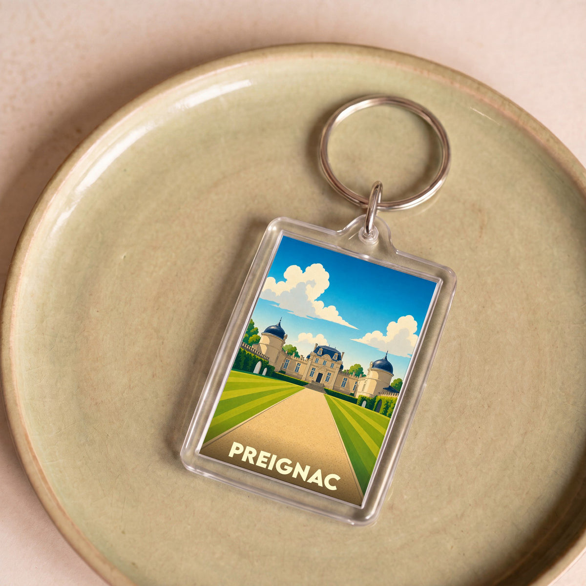 Porte-clés souvenir de la ville de Preignac avec une illustration stylisée de château.