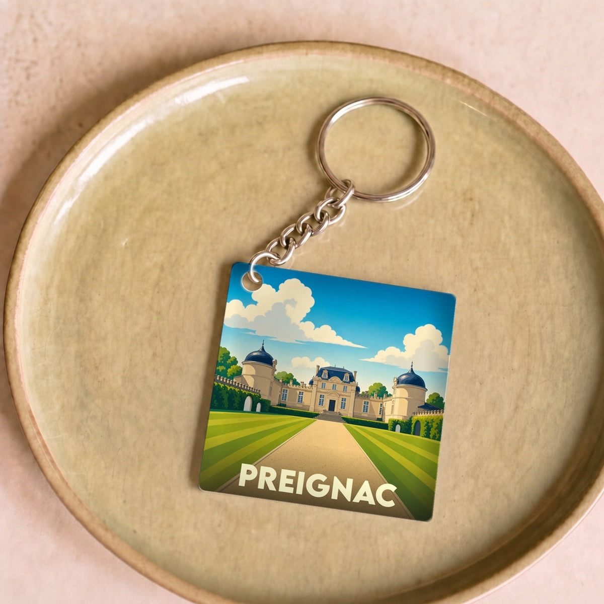 Porte-clés souvenir de la ville de Preignac avec une illustration stylisée de château.