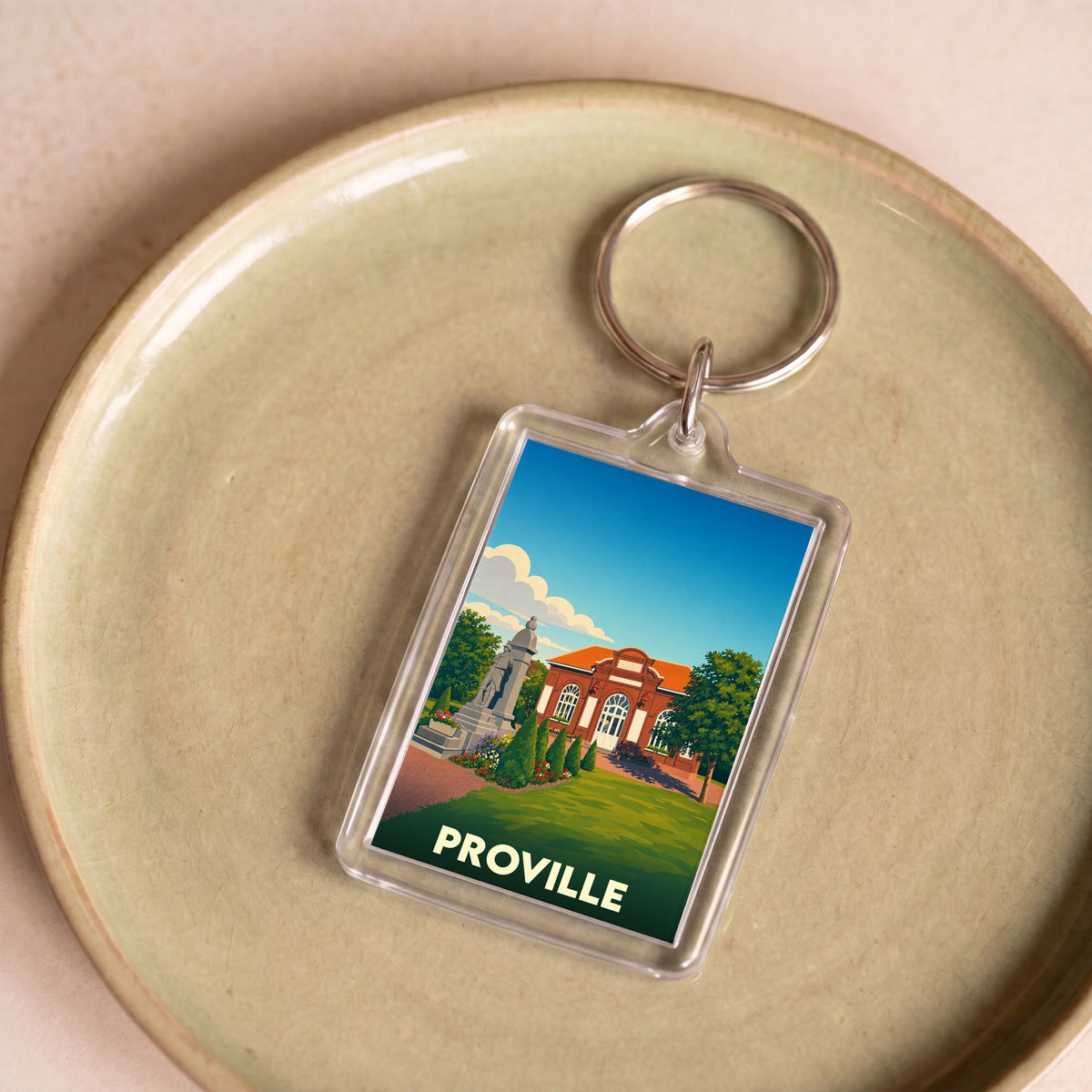 Porte-clés souvenir de la ville de Proville avec une illustration stylisée.