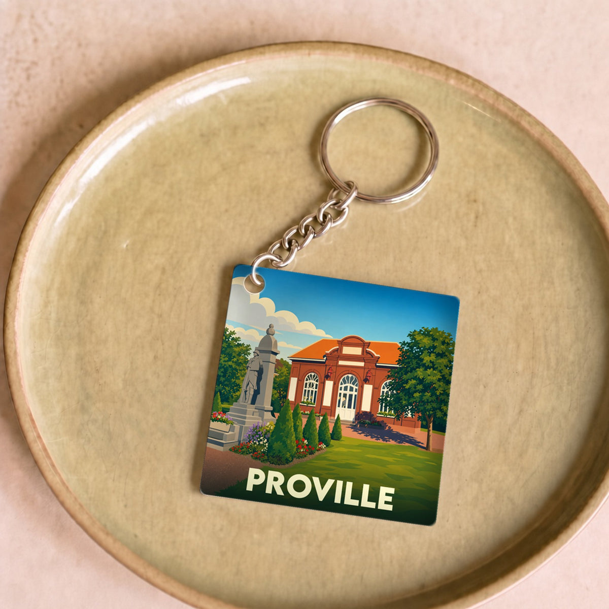 Porte-clés souvenir de la ville de Proville avec une illustration stylisée.