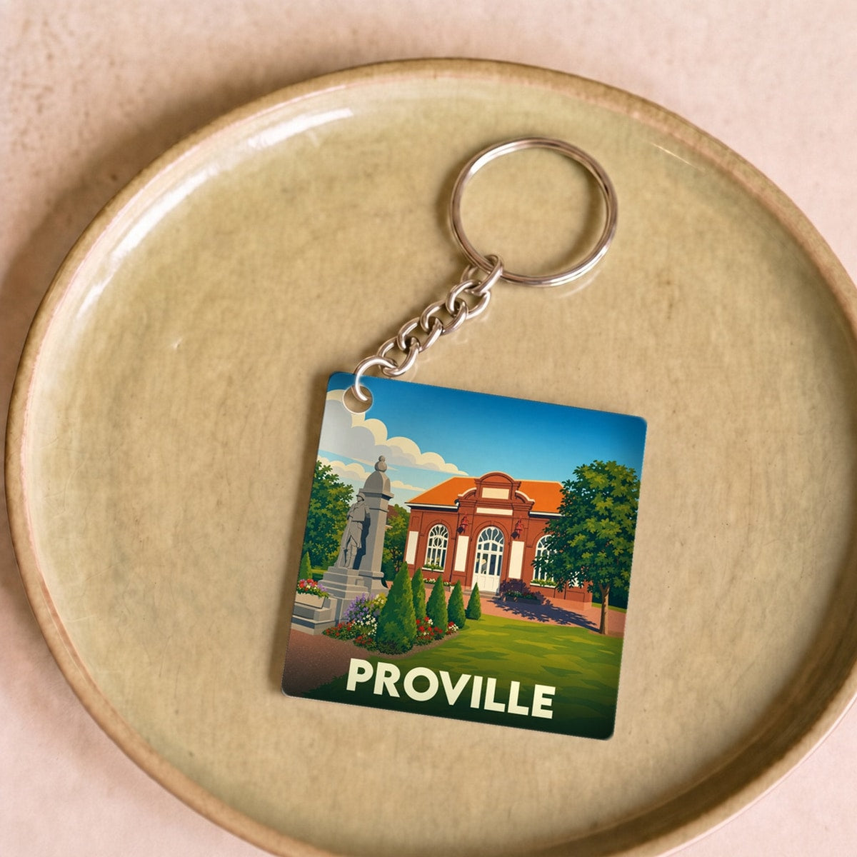 Porte-clés souvenir de la ville de Proville avec une illustration stylisée.