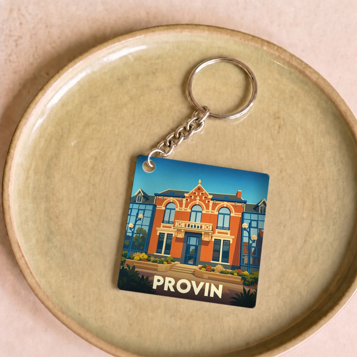 Porte-clés souvenir de la ville de Provin avec une illustration stylisée de son architecture.