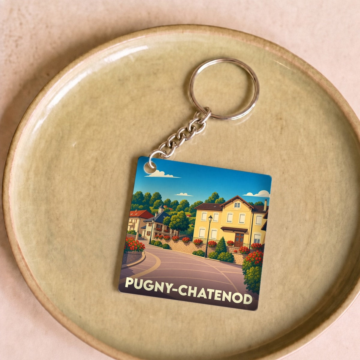 Porte-clés souvenir de la ville de Pugny-Chatenod avec une illustration stylisée.